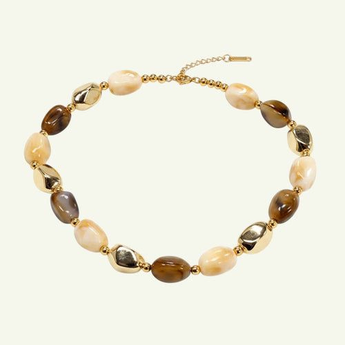 Anzora Jewel Amber & Alloy necklace with amber-brown beads, creamy stones, and polished gold-tone accents.