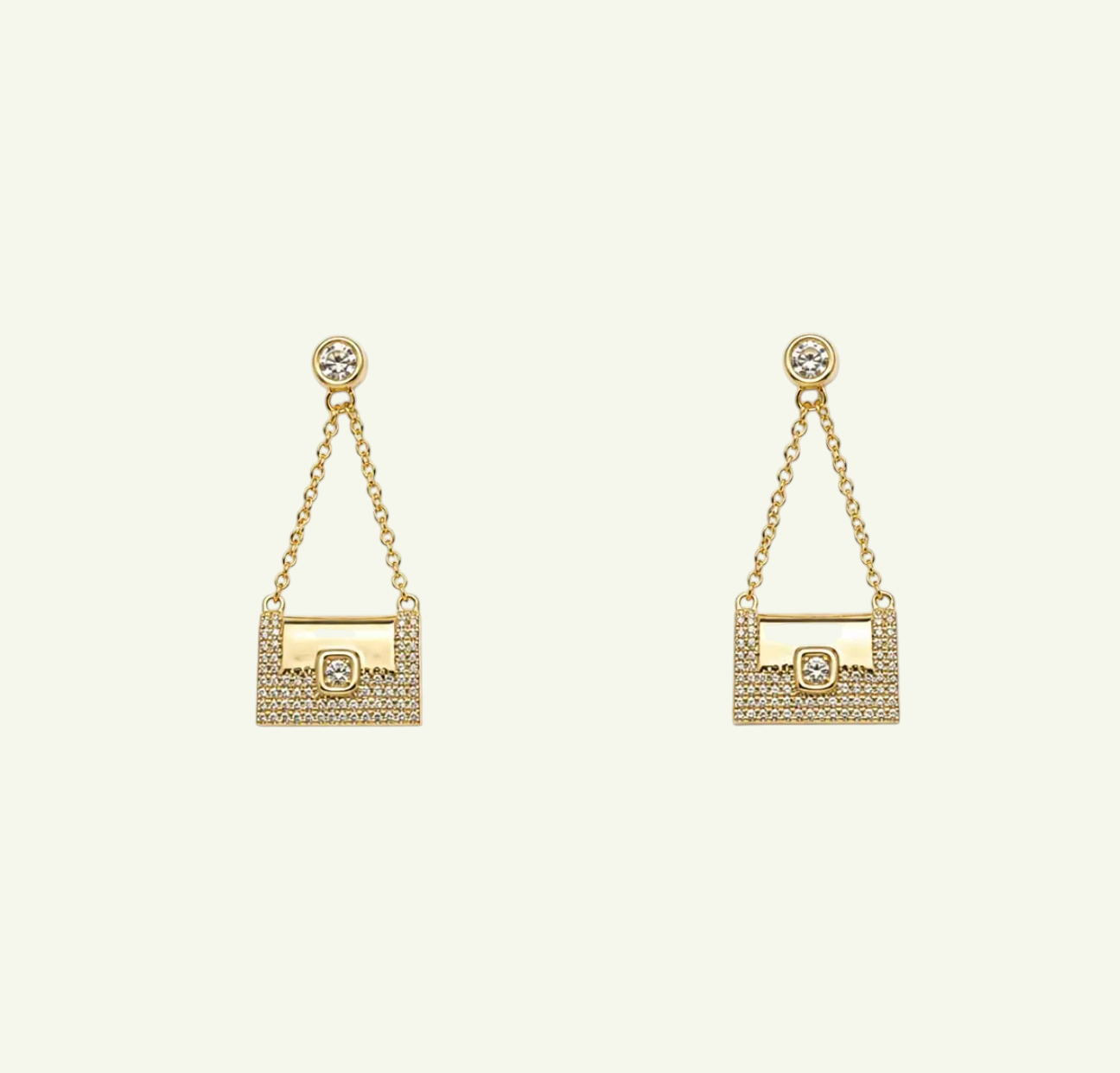 Anzora Jewel Celaeno gold drop earrings featuring a miniature handbag design with sparkling pavé crystals