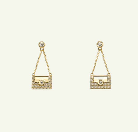 Anzora Jewel Celaeno gold drop earrings featuring a miniature handbag design with sparkling pavé crystals