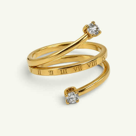 Anzora Jewel Chronos wrap ring in polished gold with Roman numeral detailing and two round-cut accent stones.