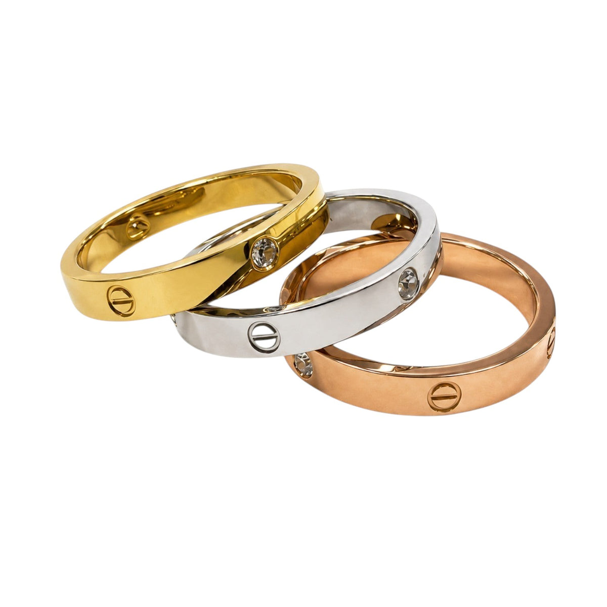 Anzora Jewel Cipher Ring Set featuring three polished bands in gold, silver, and rose-gold with engraved emblems.