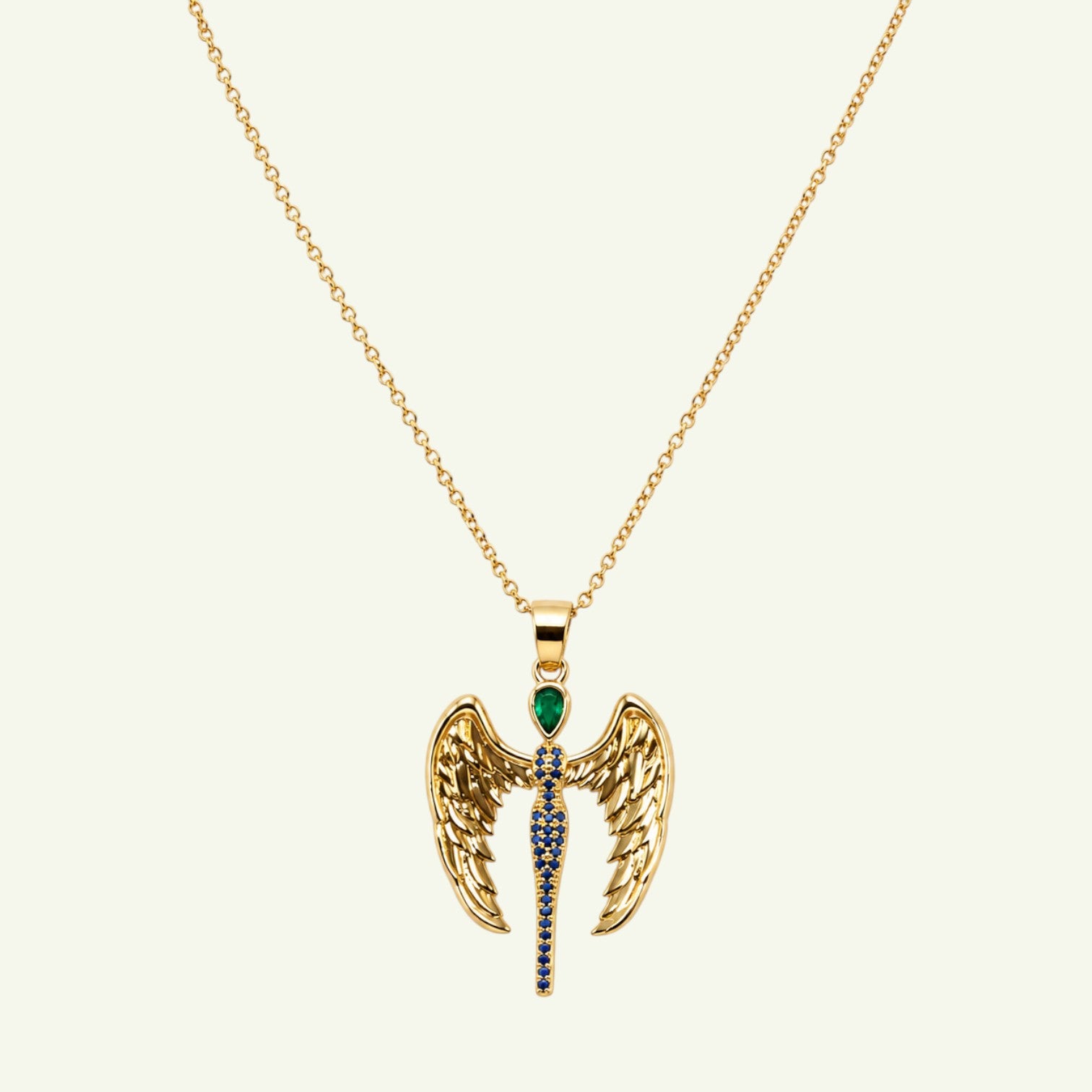 Anzora Jewel Dragon Angel necklace featuring gold wings, a teardrop emerald stone, and blue sapphire accents.
