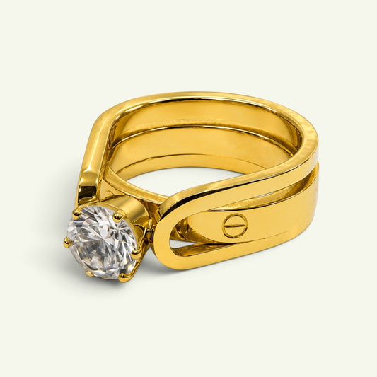 Anzora Jewel Dual Grace Ring featuring a polished gold-toned open band with a brilliant round-cut clear stone.