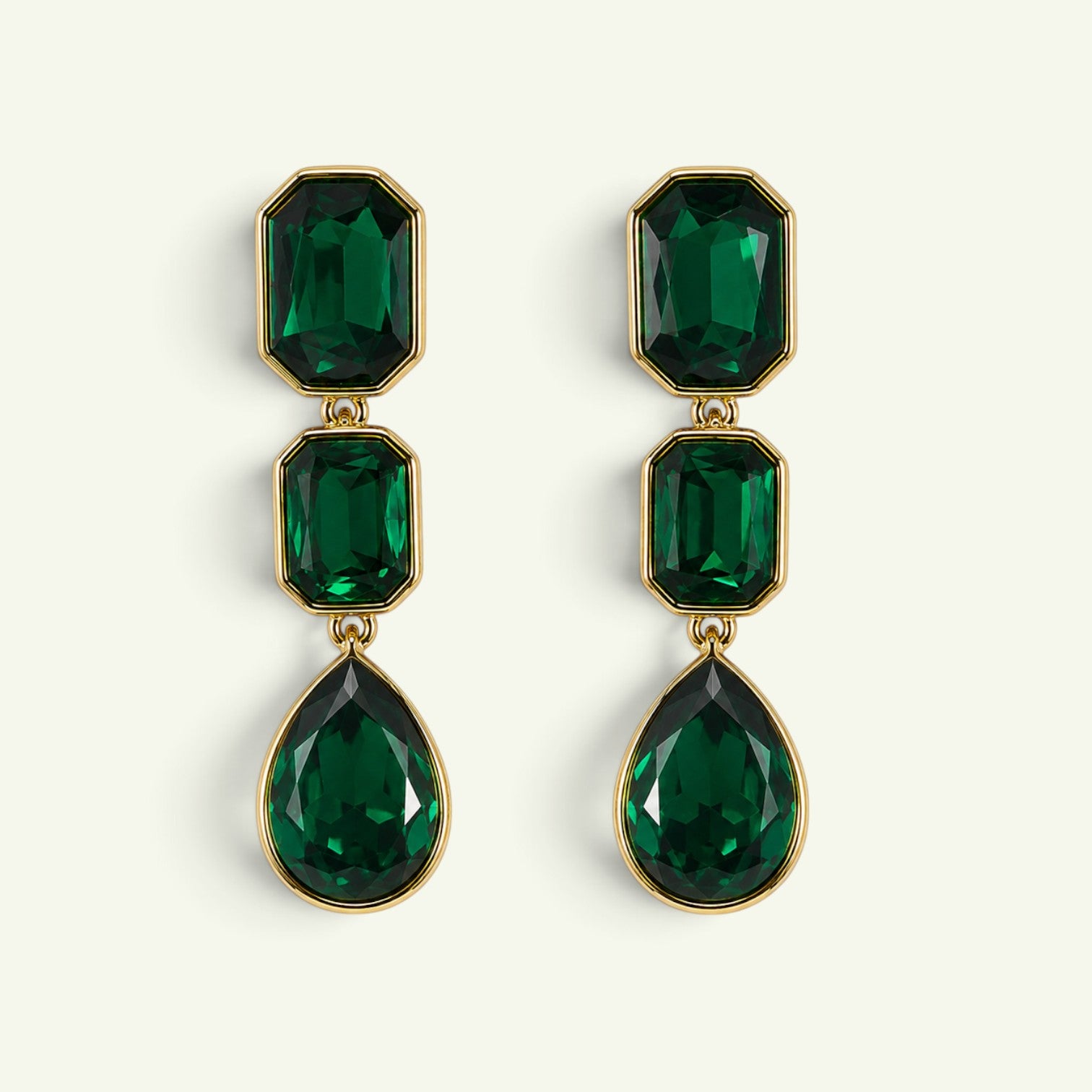 Anzora Jewel emerald green crystal drop earrings featuring three faceted stones in gold bezel settings.
