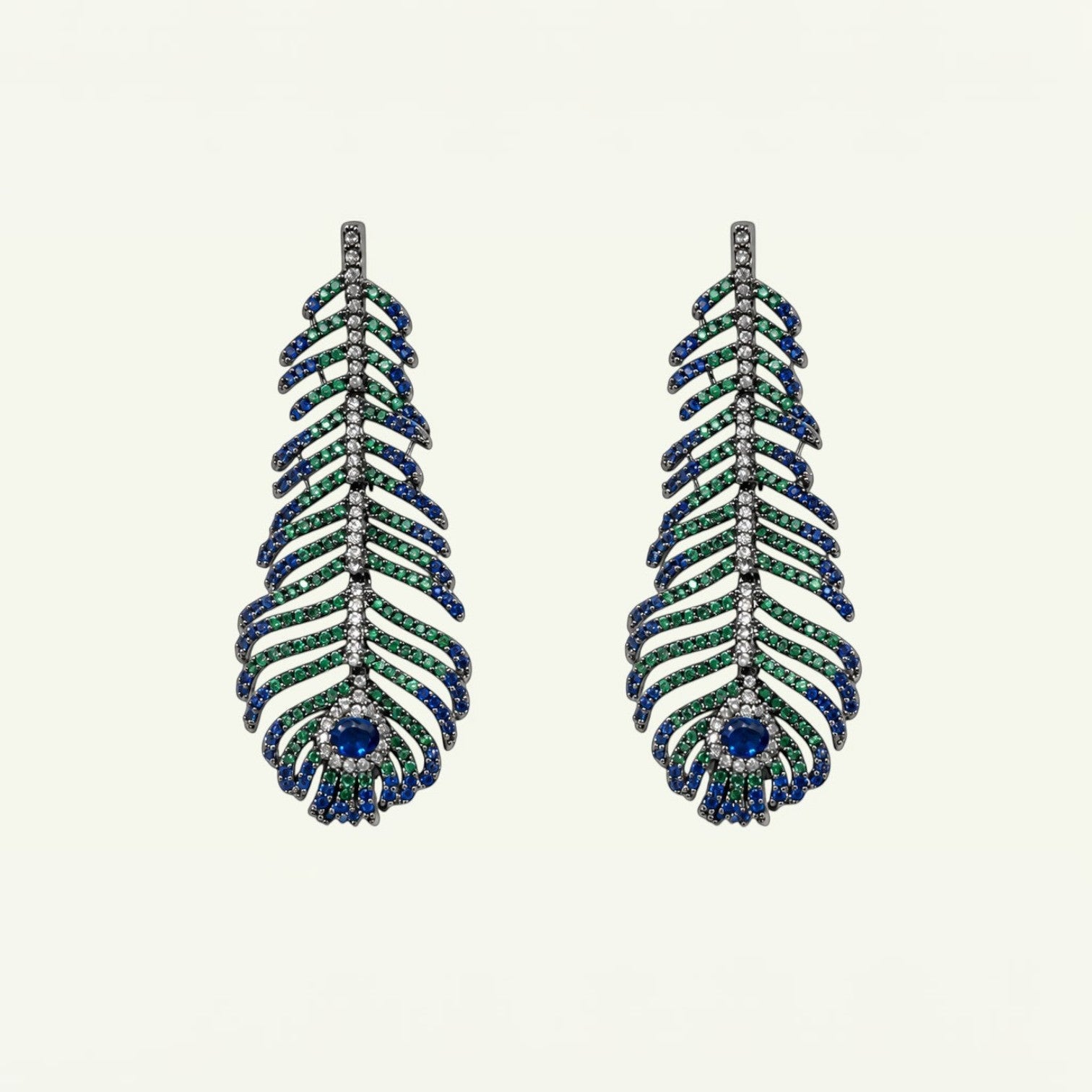 Anzora Jewel Featheris drop earrings featuring sapphire-blue, emerald-green, and clear stones on a gunmetal frame.
