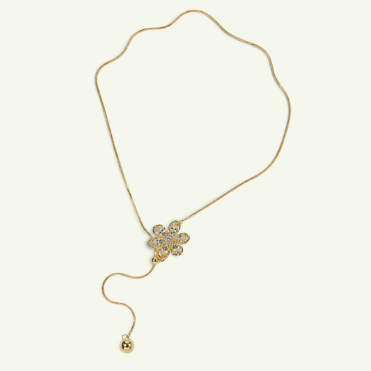 Anzora Jewel Floret adjustable gold-toned lariat necklace featuring a sparkling flower pendant and spherical drop.