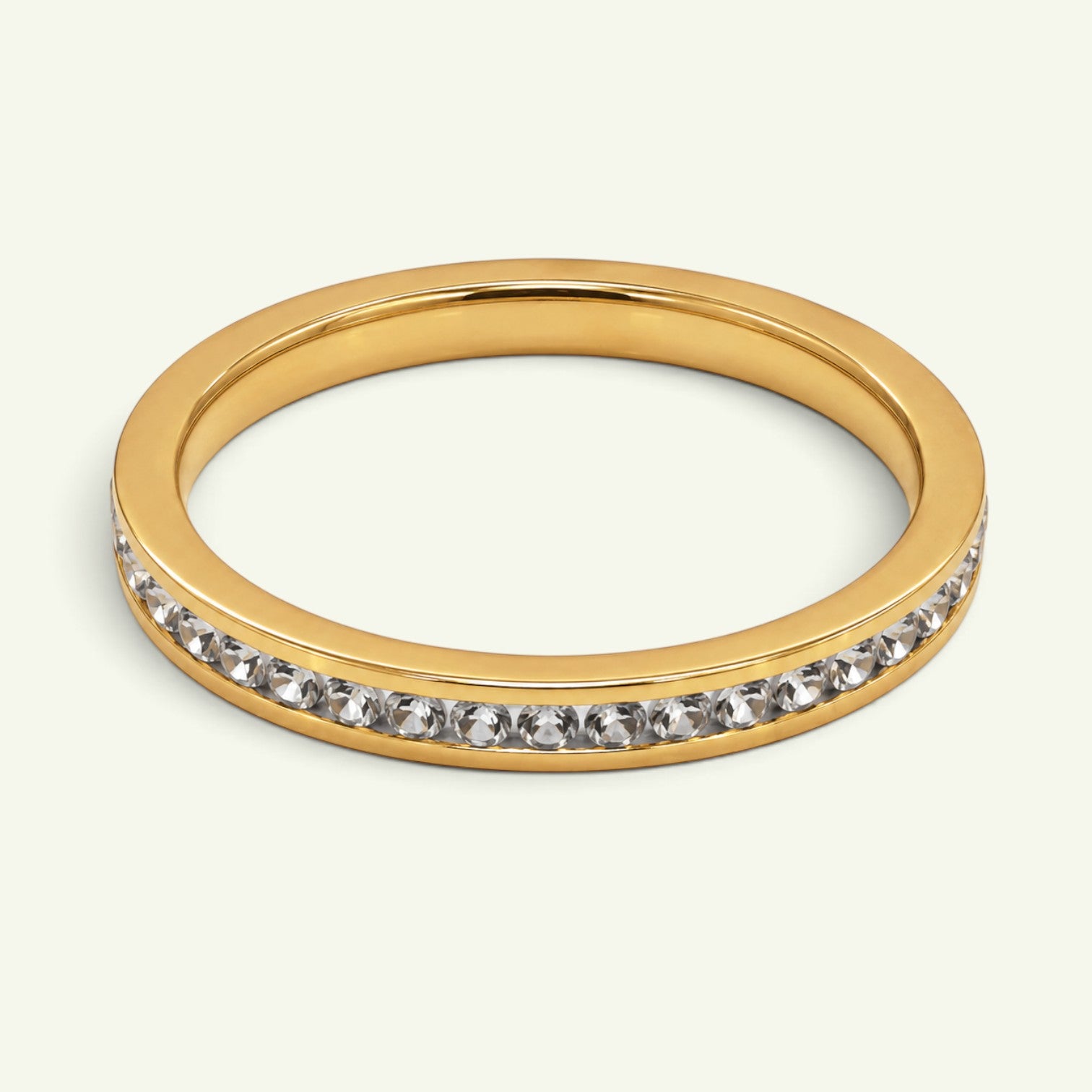 Anzora Jewel gold-toned channel eternity ring featuring a continuous row of brilliant clear stones.
