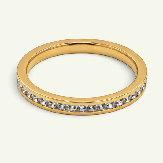 Anzora Jewel gold-toned channel eternity ring featuring a continuous row of brilliant clear stones.