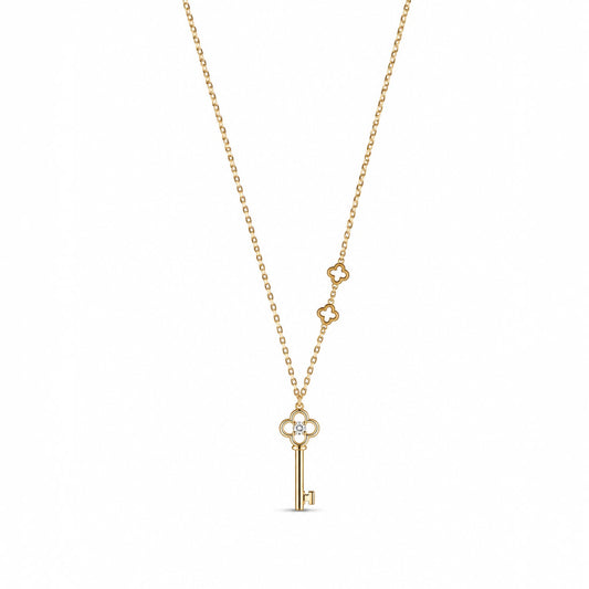 Anzora Jewel Keylisse Delicate gold necklace featuring a key pendant with a sparkling stone and floral accents.