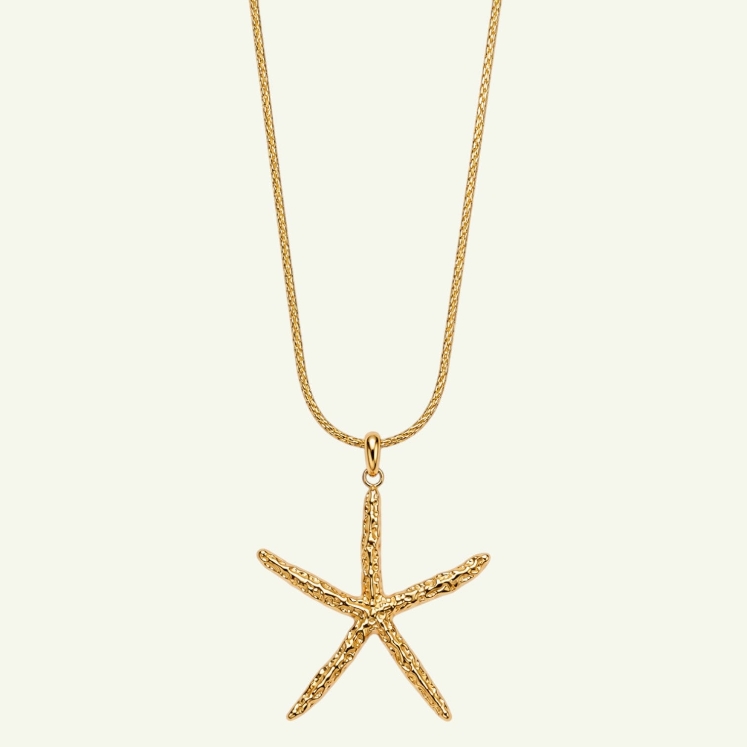 Anzora Jewel Coral Star necklace featuring a textured gold starfish pendant on a delicate matching chain.