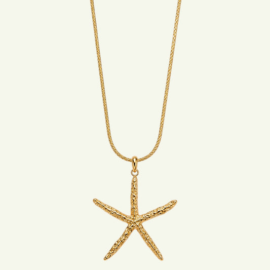 Anzora Jewel Coral Star necklace featuring a textured gold starfish pendant on a delicate matching chain.