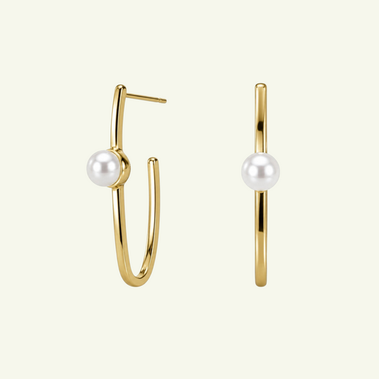 Anzora Jewel Lunara white gold hoop earrings featuring a single lustrous pearl on each minimalist curved bar