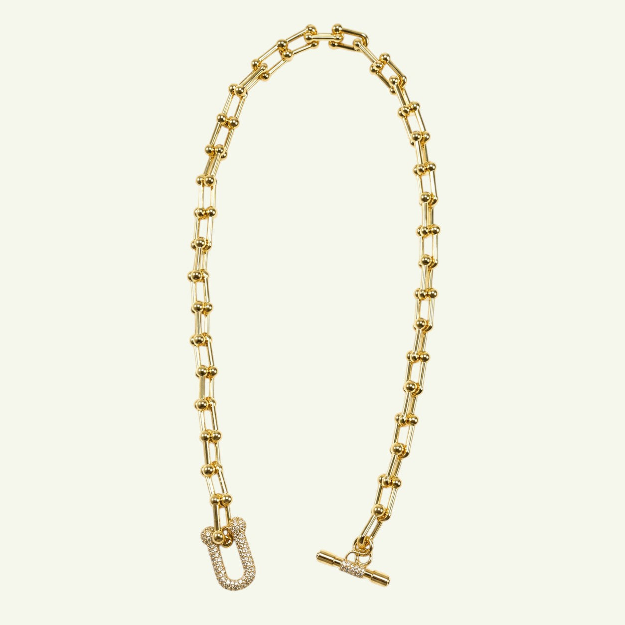 Anzora Jewel Nova Necklace featuring a gold gauge link chain with bead accents and a crystal-encrusted U-shaped link.