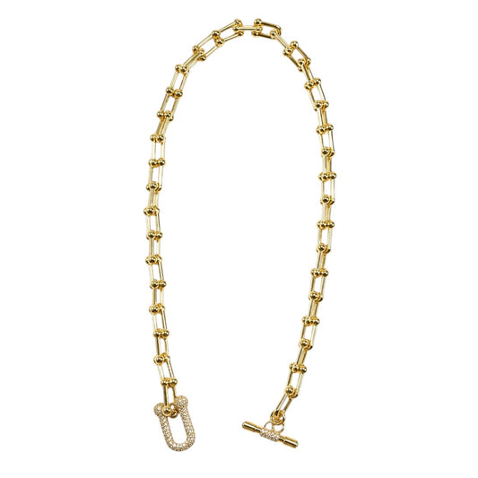 Anzora Jewel Nova gold chain necklace with spherical bead accents and a crystal-encrusted U-shaped toggle clasp.