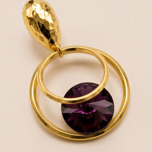 Anzora Jewel Orbit statement earrings featuring a hammered gold stud, nested gold hoops, and a deep purple crystal.