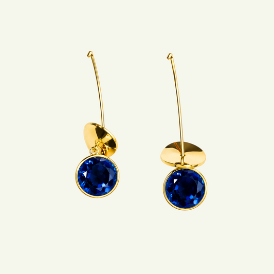 Anzora Jewel Orion Blue earrings featuring round deep blue sapphire stones set in polished gold drop stems