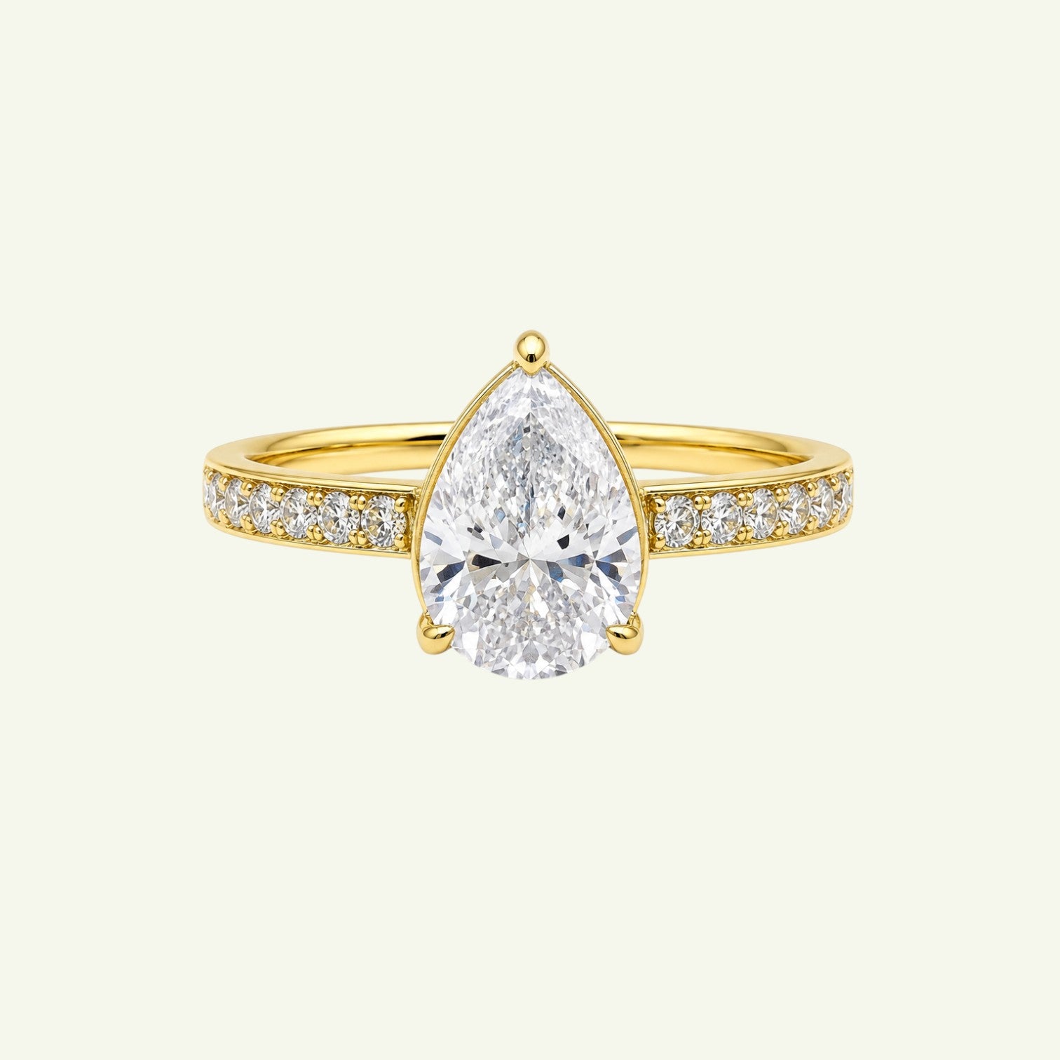Anzora Jewel Aurelle ring featuring a pear-shaped brilliant-cut stone set in polished gold with a diamond-set band.