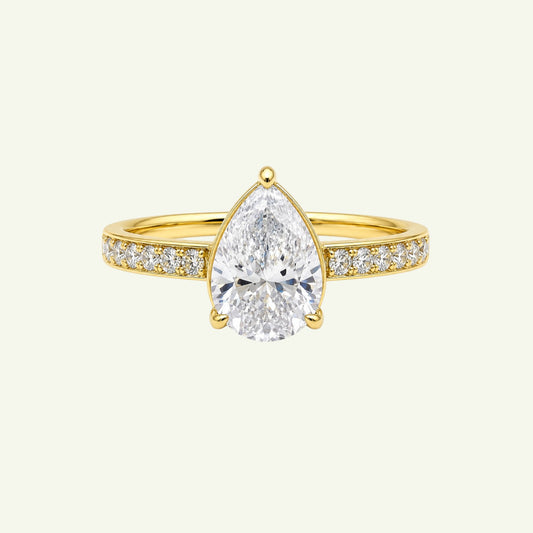 Anzora Jewel Aurelle ring featuring a pear-shaped brilliant-cut stone set in polished gold with a diamond-set band.