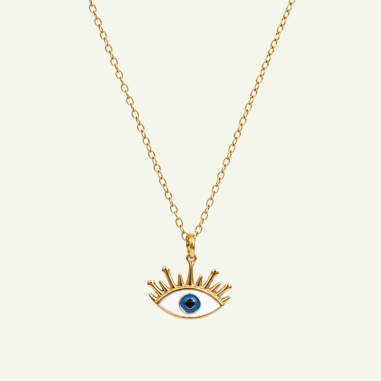 Anzora Jewel Radiant Aegis necklace featuring a gold evil eye pendant with white, blue, and black enamel details.