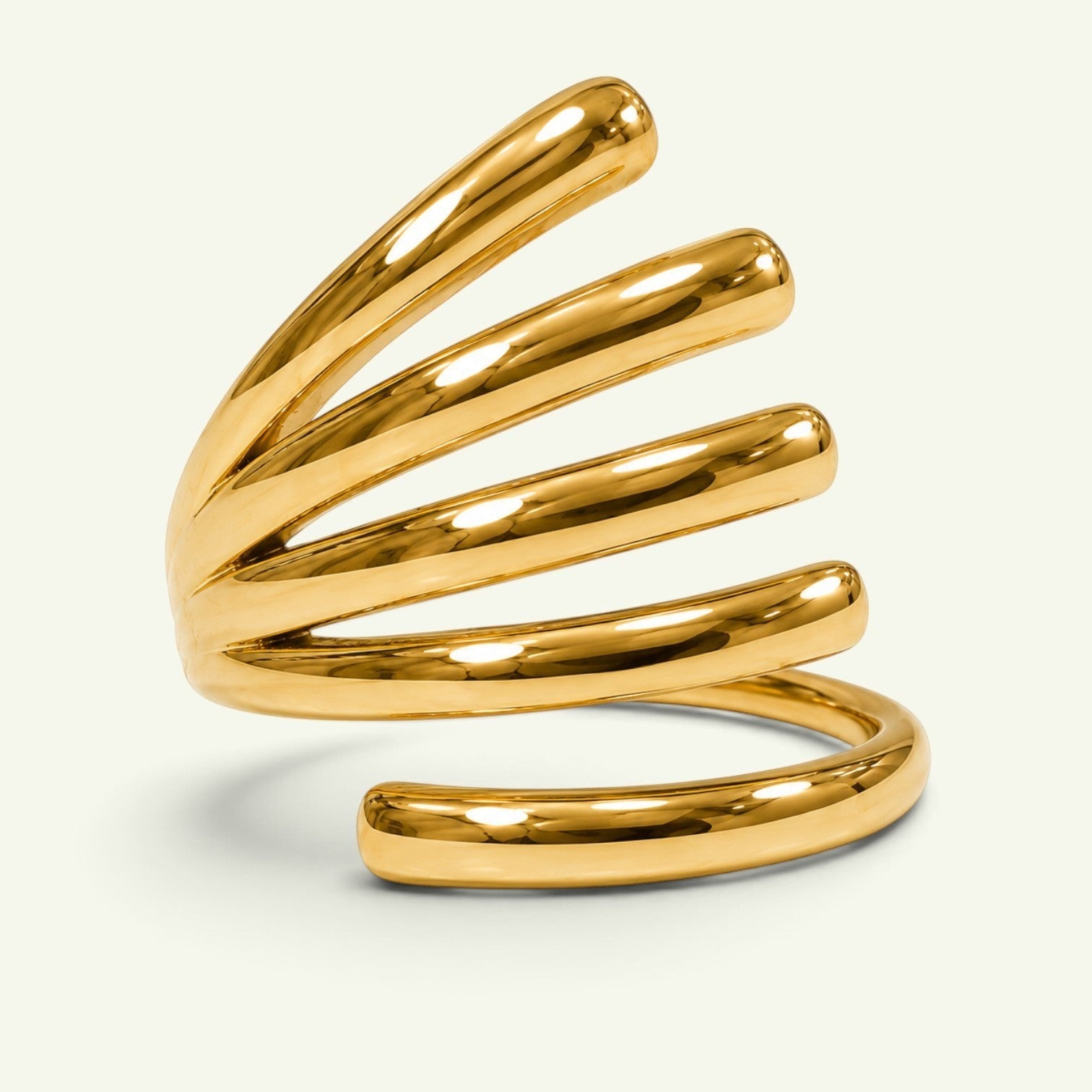 Anzora Jewel Vortex Coil Ring featuring a polished gold-tone finish with a sculptural, spiraling multi-band design.